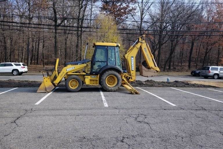GradeCraft backhoe loader performing site work in Warren County NJ